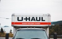 U-Haul moving truck parked on roadside with scenic outdoor backdrop.
